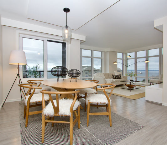 Round dining table and chairs in front of a separate living area in a Belltown condo.