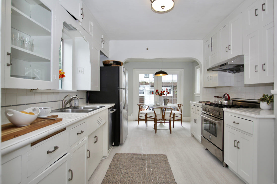 View through a bright kitchen to an adjoining dining area in a Nob Hill Style staged home.